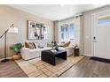 Cozy living room with stylish furniture, large window, and plenty of natural light at 1380 S Boston Ct # A, Denver, CO 80247