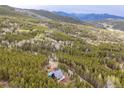 Secluded cabin nestled in a lush forest with stunning mountain views at 352 Apache Rd, Evergreen, CO 80439