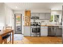 Bright kitchen featuring butcher block countertops, stainless steel appliances, and wooden floor at 352 Apache Rd, Evergreen, CO 80439