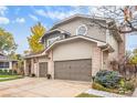 Beautiful home showcasing a three-car garage, brick accents and mature landscaping at 11687 Decatur Dr, Westminster, CO 80234