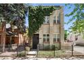 A two-story apartment building featuring climbing vines at 1532 N High St # 1, Denver, CO 80218