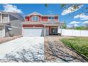 Inviting two-story home with a front porch and attached two-car garage at 5552 Odessa St, Denver, CO 80249