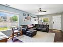 Cozy living room with a comfortable leather sectional and abundant natural light at 5552 Odessa St, Denver, CO 80249