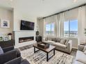 Spacious living room with a fireplace, large windows with great views, and hardwood flooring at 14440 Hop Clover Trl, Parker, CO 80134