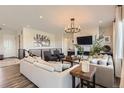 Inviting living room featuring a fireplace, stylish furnishings, and plenty of natural light at 14440 Hop Clover Trl, Parker, CO 80134