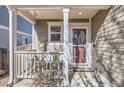 Covered front porch with a swing, providing a relaxing outdoor space at 10699 Durango Pl, Longmont, CO 80504