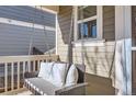 Relaxing front porch swing on a covered porch at 10699 Durango Pl, Longmont, CO 80504