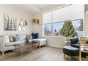 Bright living room with a large window, comfortable seating, and stylish decor, creating a welcoming space at 5385 W 14Th Ave, Lakewood, CO 80214