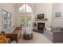 Bright living room with vaulted ceilings, fireplace, view, and balcony access at 218 Highland Ter, Breckenridge, CO 80424