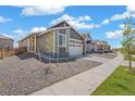 Beautiful modern home featuring desert landscaping, fenced yard and a two-car garage at 9314 Biscay St, Commerce City, CO 80022
