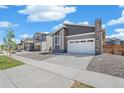 Beautiful modern home featuring desert landscaping, fenced yard and a two-car garage at 9314 Biscay St, Commerce City, CO 80022