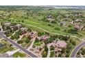 Aerial view of luxurious homes nestled within a lush, green golf course community at 4651 Sonado Pl, Parker, CO 80134