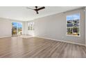 Bright and airy living room featuring wood floors, fan, and plenty of natural light at 17692 Olive St, Broomfield, CO 80023