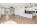 Open-concept living space with wood floors, large windows, and modern finishes at 17692 Olive St, Broomfield, CO 80023