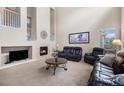 Living room featuring a fireplace and high ceilings at 14058 Elizabeth St, Thornton, CO 80602
