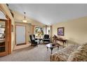 Comfortable living room with neutral walls, carpeted floors, and traditional furnishings at 13112 Summit Grove Pkwy, Thornton, CO 80241
