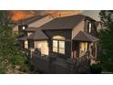 Charming townhome with stone accents, a private balcony, and warm evening glow at 3985 W 104Th Dr # E, Westminster, CO 80031
