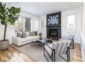Bright living room featuring a fireplace, hardwood floors, and neutral décor at 2646 S Madison St, Denver, CO 80210