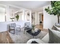 Open living space featuring modern furnishings and a decorative Fiddle-leaf Fig tree at 2646 S Madison St, Denver, CO 80210