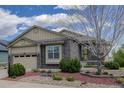 Charming exterior of a home featuring stone accents and manicured landscaping at 15088 Verbena St, Thornton, CO 80602