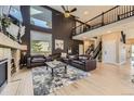 Spacious living room featuring high ceilings, large windows, and a comfortable leather seating area at 7378 Geode Ct, Castle Rock, CO 80108