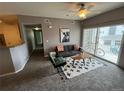 Comfortable living room with a view of the balcony at 15700 E Jamison Dr # 3-202, Englewood, CO 80112