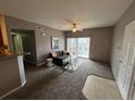 Cozy living area with neutral tones and access to the outdoor balcony at 15700 E Jamison Dr # 3-202, Englewood, CO 80112