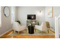 Cozy living room featuring neutral decor, sleek furnishings, and natural light at 8427 E 35Th Ave, Denver, CO 80238
