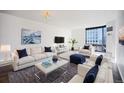 Bright living room featuring plush seating, modern décor, and expansive windows with city views at 1625 Larimer St # 3004, Denver, CO 80202