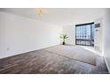 Spacious living room with sleek wood floors and large windows offering city views at 1625 Larimer St # 3004, Denver, CO 80202