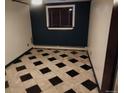 Cozy room featuring black and white checkered tile flooring and a single window at 8822 E Florida Ave # G07, Denver, CO 80247