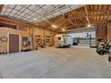 Spacious garage with high ceilings offering ample storage for vehicles and outdoor gear at 11524 Spruce Mountain Rd, Larkspur, CO 80118