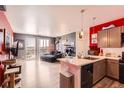 Modern living room with an open floor plan, balcony, updated kitchen and stylish décor at 8475 E 36Th Ave # 337, Denver, CO 80238