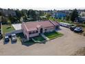 Lovely home exterior boasts a welcoming entrance and well-manicured lawn at 5400 S Alkire St, Littleton, CO 80127