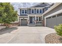Charming two-story home with a three-car garage, landscaped front yard, and a concrete driveway at 9527 Iron Mountain Way, Arvada, CO 80007