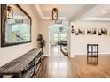 Bright foyer featuring hardwood floors, decorative mirror, and stylish lighting at 9527 Iron Mountain Way, Arvada, CO 80007