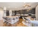 Spacious kitchen features a large center island, sleek black cabinetry, and modern stainless steel appliances at 10811 Chambers Way, Commerce City, CO 80022