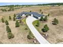 Spacious home with long driveway and lots of trees on a large lot in a field at 2937 Hidden Den Ct, Franktown, CO 80116