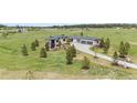 Expansive home on a large lot featuring a long driveway and well-maintained landscaping at 2937 Hidden Den Ct, Franktown, CO 80116