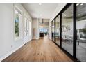 Bright hallway with hardwood floors, large sliding glass doors, and views of the living area at 2937 Hidden Den Ct, Franktown, CO 80116