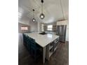 Modern kitchen featuring a large island with seating, stainless steel appliances, and ample cabinet space at 2242 S Uravan St, Aurora, CO 80013