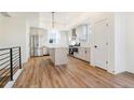 Bright, open kitchen featuring stainless steel appliances, a kitchen island and hardwood floors at 5725 W 91St Ave, Westminster, CO 80031