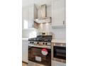 Close-up of stainless steel range and backsplash in kitchen area, modern design at 5725 W 91St Ave, Westminster, CO 80031