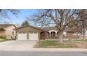 Well-maintained brick home with a two-car garage, attractive landscaping, and a welcoming entrance at 2696 S Yukon Ct, Lakewood, CO 80227