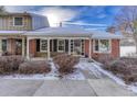 Charming brick home with a covered porch and a well-maintained front yard at 8621 E Yale Ave # F, Denver, CO 80231