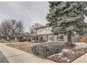 Traditional home featuring a well-kept lawn and classic architectural details at 4055 S Niagara Way, Denver, CO 80237
