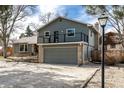 Charming two-story home with a two car garage, brick accents, neutral paint, and upper deck at 8025 S Cody St, Littleton, CO 80128