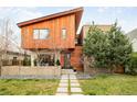Striking modern home with wood siding, contemporary design, and professionally landscaped front yard at 1452 S Washington St, Denver, CO 80210