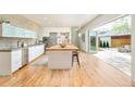 Bright, open kitchen featuring a butcher block island, stainless steel appliances, and seamless indoor/outdoor flow at 1452 S Washington St, Denver, CO 80210