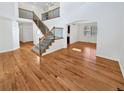 Bright open-concept living space features wood floors, staircase, and an abundance of natural light at 2180 Trailblazer Way, Castle Rock, CO 80109